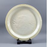 ROBERT GRUNDY (born 1938); a porcelain charger with impressed fossil decoration, diameter 38.5cm.