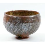 ALEX SHIMWELL (born 1980); a stoneware bowl covered in gold shino and ash glaze with lustrous