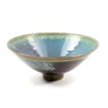 SUTTON TAYLOR (born 1943); an earthenware bowl covered in mottled iridescent lustrous turquoise