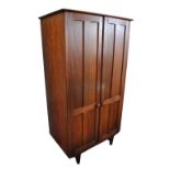 JOHN HERBERT FOR YOUNGER LTD; a teak two door wardrobe with fielded detail to front and mirror to