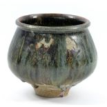 ISKANDAR JALIL; a stoneware footed bowl partially covered in running green and tenmoku glaze,