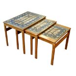 OX ART; a 1970s Danish teak nest of three tables, each set with stoneware tiles, the two larger