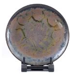 ABDO NAGI (1941-2001); a stoneware charger covered in mottled pink and blue glaze, diameter 40cm. (