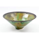 EMMANUEL COOPER (1938-2012); a conical porcelain bowl covered in green glaze with bronze rim,