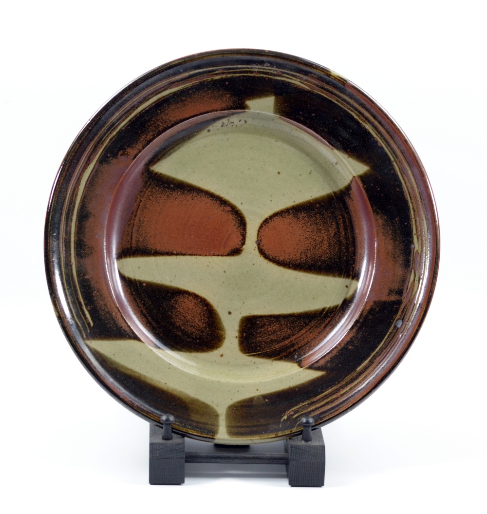 RAY FINCH (1914-2012) for Winchcombe Pottery; a stoneware charger covered iron-rich glaze with wax