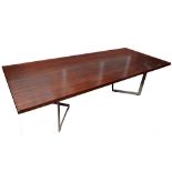 A large 1970s rosewood veneered boardroom/dining table with rectangular top above twin chrome angled