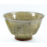 JIM MALONE (born 1946); a stoneware footed bowl covered in green ash glaze with incised grass