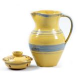 Kingwood Pottery; a stoneware jug decorated with bands of blue on a pale yellow ground, impressed