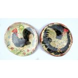BEN FOSKER (born 1960); a pair of slip decorated earthenware plates depicting cockerels, painted B