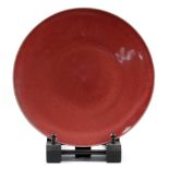 RUPERT SPIRA (born 1960); a stoneware plate covered in red copper glaze, impressed RS mark, made