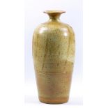Winchcombe Pottery; a stoneware bottle covered in oatmeal glaze with incised decoration, impressed
