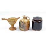 ANDREW YOUNG (born 1949) & JOANNA YOUNG (born 1950); a small salt-glazed tea strainer and stand,