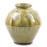 MIKE DODD (born 1943); a stoneware vase covered in green ash glaze with incised and impressed