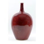 RUPERT SPIRA (born 1960); a large stoneware bottle covered in copper red glaze, height 35cm. (D)