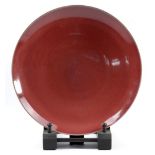 RUPERT SPIRA (born 1960); a stoneware plate covered in red copper glaze, impressed RS mark, made