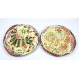 BEN FOSKER (born 1960); a pair of slip decorated earthenware plates depicting a lion and tiger,