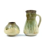 BARBARA CASS (1921-1992); a stoneware jug and vase decorated with running green ash glaze, incised