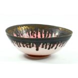 PETER WILLS (born 1955); a porcelain bowl covered in pink and running manganese glaze, impressed and