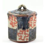 JOHN MALTBY (born 1936); an octagonal stoneware jar and cover, stylised pattern alternating with