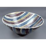 A large stoneware bowl decorated with bands of red, blue and gold, impressed J mark, diameter 42.