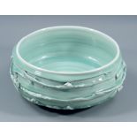 ALEX SHIMWELL (born 1980); a heavily textured porcelain bowl covered in celadon glaze, impressed S