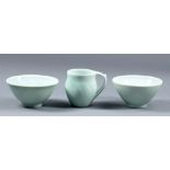 DEREK EMMS (1929-2004); two porcelain bowls and a jug, pale green celadon glaze and incised leaf