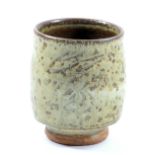 JIM MALONE (born 1946); a stoneware yunomi covered in mottled green ash glaze with incised