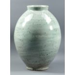 ANDY PRIESTMAN; a large stoneware vase decorated with iron spots on a pale green hakeme ground,