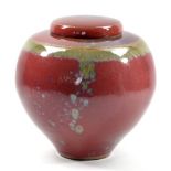 PETER SPARREY (born 1967); a stoneware jar and cover decorated with copper red and green ash