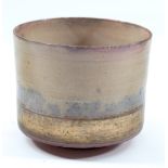 ROBIN WELCH (born 1936); a cylindrical stoneware vessel with gold lustre band, impressed name,