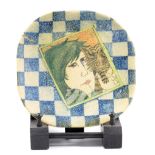 AMANDA POPHAM (born 1954) for Liberty; an earthenware plate decorated with a woman's face and cat on