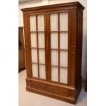 An early-to-mid 20th century mahogany twin-door wardrobe cabinet,