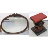 An Edwardian oak oval decorative wall mirror with floral and swag decoration to the top,