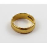 A 22ct gold wedding band, size O, approx 8.4g.