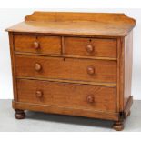 A Victorian/Edwardian two-over-two chest of drawers to plinth base and bun supports,