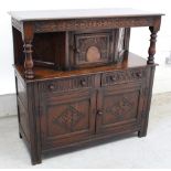 A mid-to-late 20th century stained oak Wood Brothers style court cupboard,