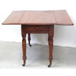 A 19th century mahogany Pembroke table on turned legs to porcelain castors,