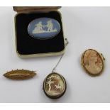 A small group of Victorian and later brooches to include an ellipse-shaped mourning brooch with