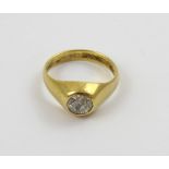 An 18ct gold gentlemen's dress ring set with a solitaire diamond, approx .75ct, size R1/2, approx 7.