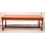 An early 20th century stained pine refectory-style dining table,