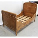 A 19th century Continental pine large single bed frame with side runners and slats,