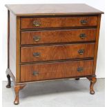 A 1930s walnut chest of four graduated drawers on cabriole legs,