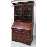 A George III mahogany bureau bookcase with glazed elevated section enclosing two later fixed