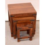 A nest of three Indian stained hardwood square tables, with metal trim to corners.