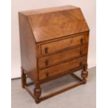 A mid-20th century oak bureau, drop-down desktop to interior pigeonholes,