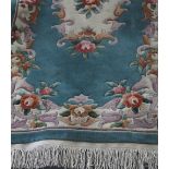 A Chinese Superwash teal ground rug with floral decoration, 196 x 92cm.