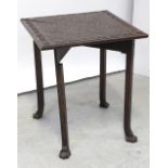 An early-to-mid 20th century carved oak corner envelope table with incised carved decoration to the