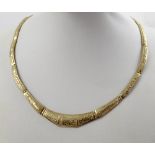 A 9ct gold Egyptian-style panel link choker with scarab and hieroglyph decoration to a textured