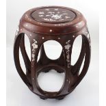 A 20th century Oriental hardwood barrel-form stool with inlaid mother of pearl decoration,