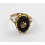 A 9ct gold mourning ring with oval onyx inset and tiny seed pearl, size P, approx 3.6g.